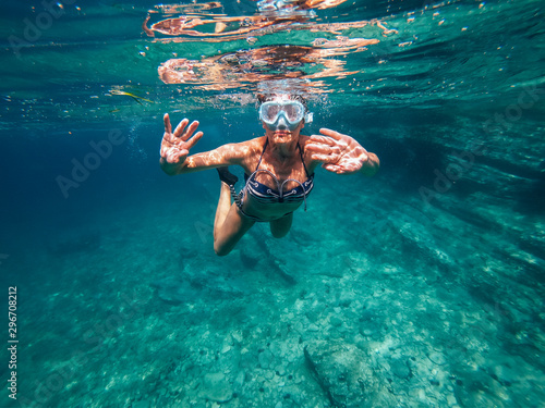 Woman snorkeling in the shallow sea water