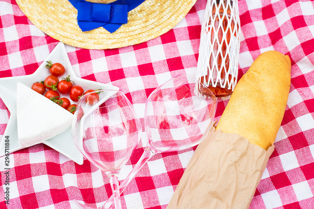 Fototapeta premium hat, glasses, bread and cheese on red tablecloth