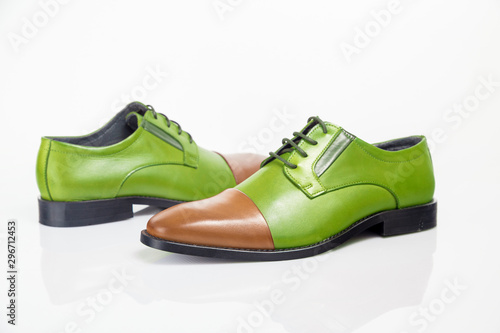 pair of green and brown shoes isolated on white background, top view.