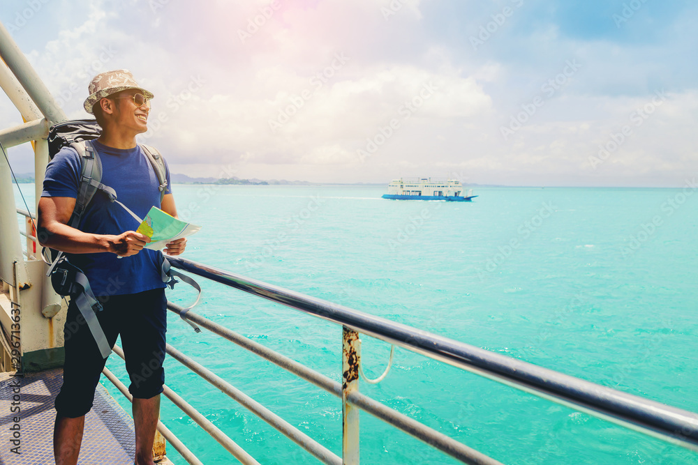 Handsome man with a map looking to destination on holiday while travel on cruise ship