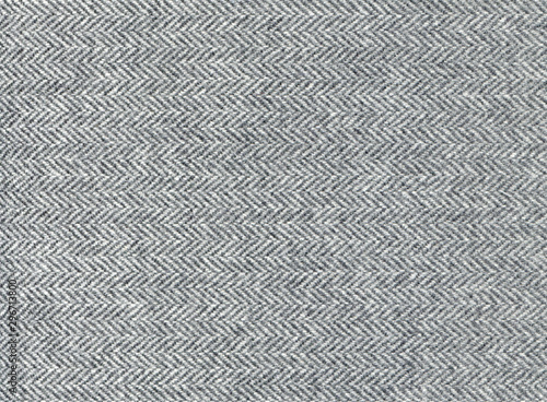 Elegant grey woolen fabric striped zigzag. Herringbone tweed, Wool Background Texture. Coat close-up. Expensive men's suit fabric. High resolution