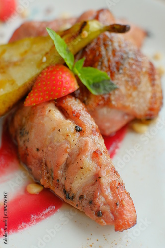 Delicious dish with pear, strawberries sauce.