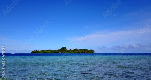 distant view of Prison Changu Island, in crystal clear water of Zanzibar archipelago, Indian ocean, Tanzania, static wide background shot with copy space photo