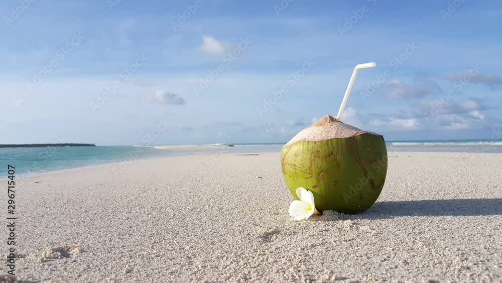 Coconut cocktail on sandy ocean beach near the water. tropical landscape. Travel concept., background close up static shot with copy space Coconut cocktail on sandy ocean beach near the water. tropical landscape. Travel concept., background close up static shot with copy space