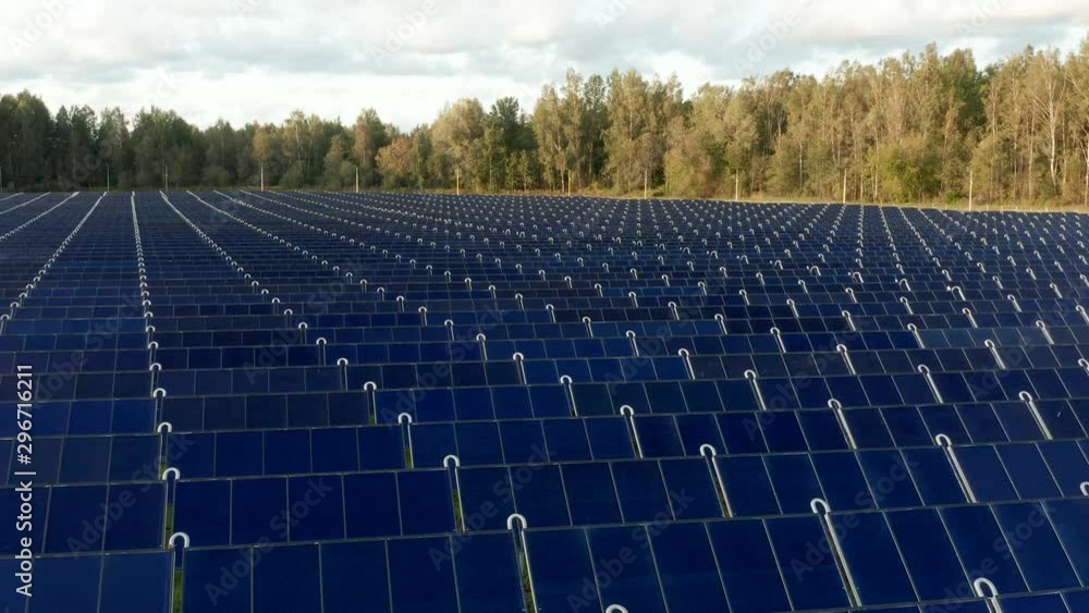 Solar thermal collectors. Solar panels farm field of green renewable energy. in the middle of a forest. Aerial drone fly over video. 4k footage Solar thermal collectors. Solar panels farm field of green renewable energy. in the middle of a forest. Aerial drone fly over video. 4k footage