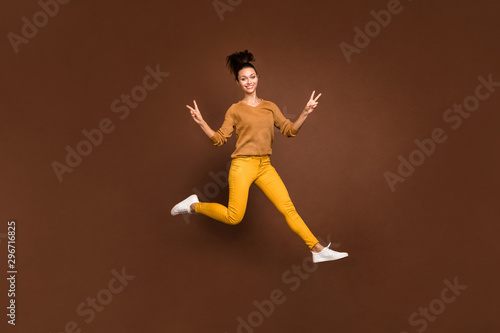 Full length body size photo of cheerful sweet gorgeous fascinating attractive girl showing you double v-sign in hurry to say hello isolated over brown pastel color background © deagreez
