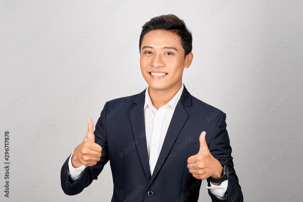Asian smiling businessman showing thumb up both hand, isolated on white background Asian smiling businessman showing thumb up both hand, isolated on white background