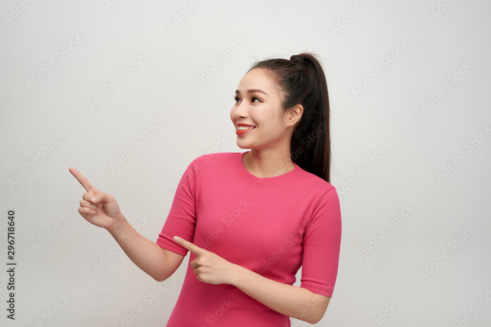 Happy surprised young female smiling broadly at camera, pointing fingers away Happy surprised young female smiling broadly at camera, pointing fingers away