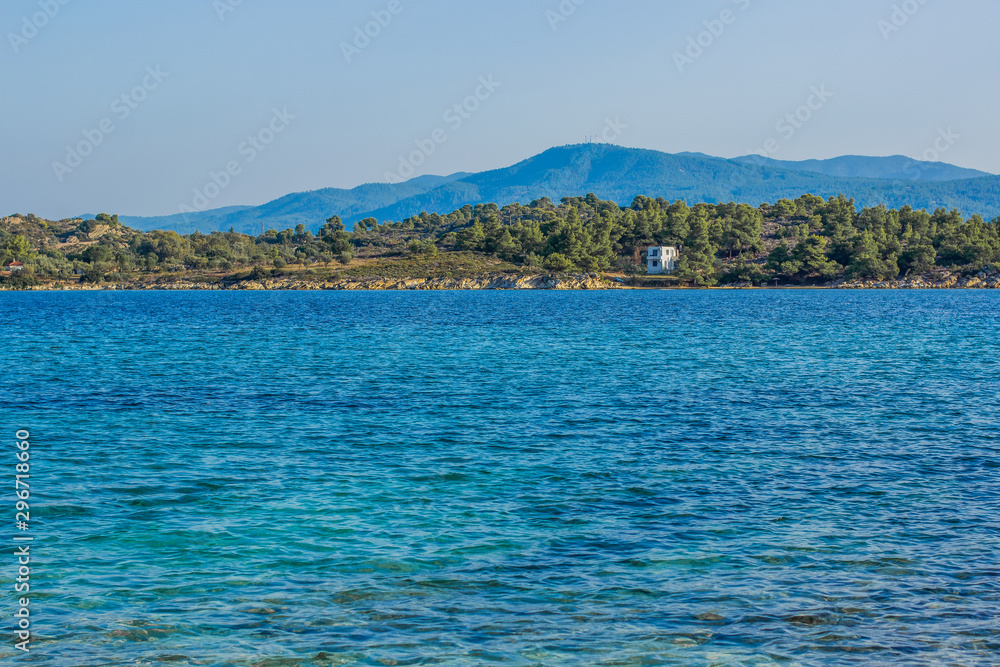 sea lagoon blue water surface and green main land with lonely cottage house simple outdoor nature reserve scenic view in summer season clear weather time 