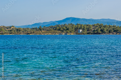 sea lagoon blue water surface and green main land with lonely cottage house simple outdoor nature reserve scenic view in summer season clear weather time  © Артём Князь