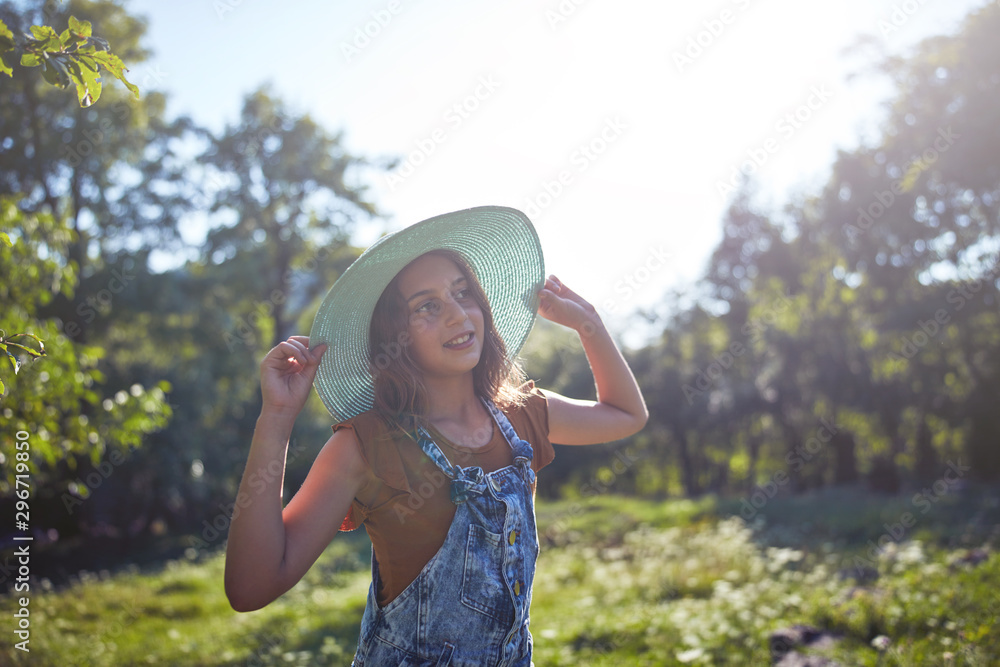 Fototapeta premium Cute ten year old girl posing in nature.