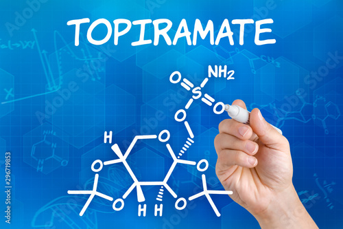 Hand with pen drawing the chemical formula of  Topiramate