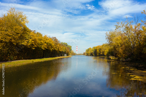 Wallpaper Mural Epic aerial flight over water. Colorful autumn trees in the daytime. Drone flies along a river with yellow trees. Warsaw. Poland. Beautiful river view with autumn trees.  Torontodigital.ca
