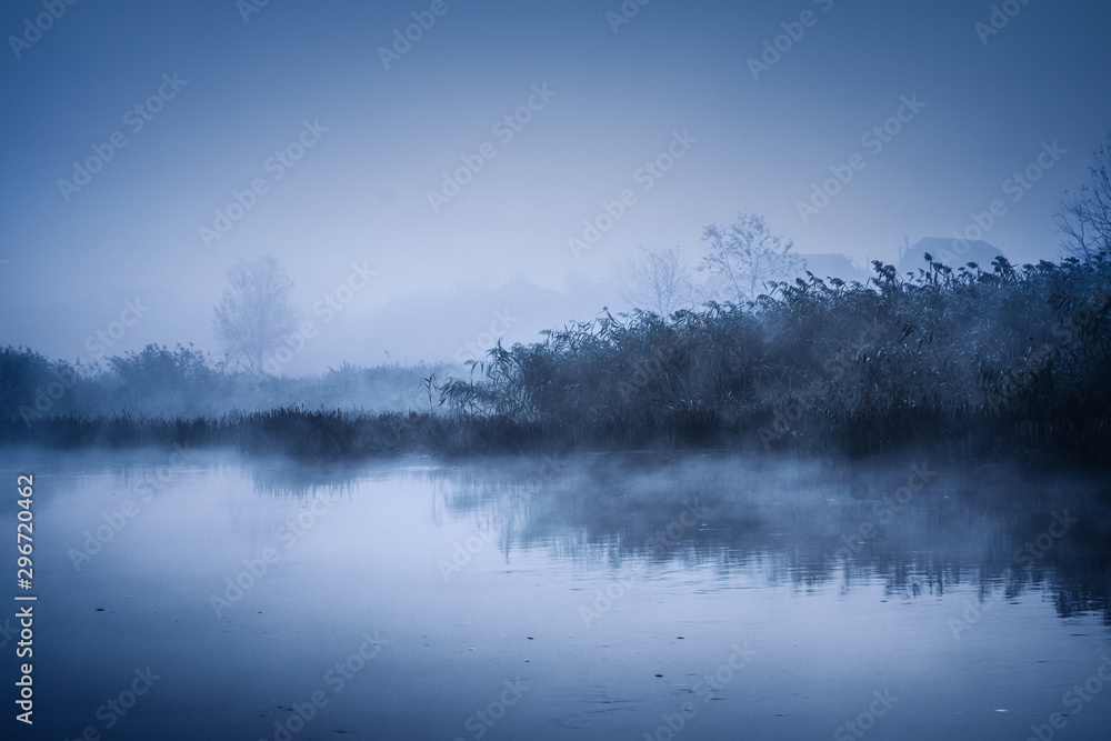 Fototapeta premium Fog over the river on a cold autumn morning