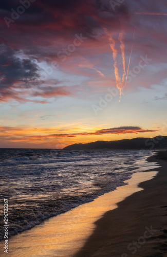 Fototapeta Naklejka Na Ścianę i Meble -  Sea landscape with dramatic sunset sky. Reflections of the sun in the shore