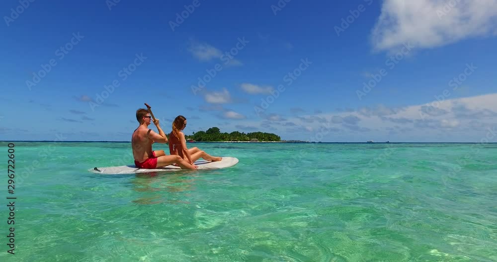 couple enjoying their time in the Philippines on a paddleboard couple enjoying their time in the Philippines on a paddleboard