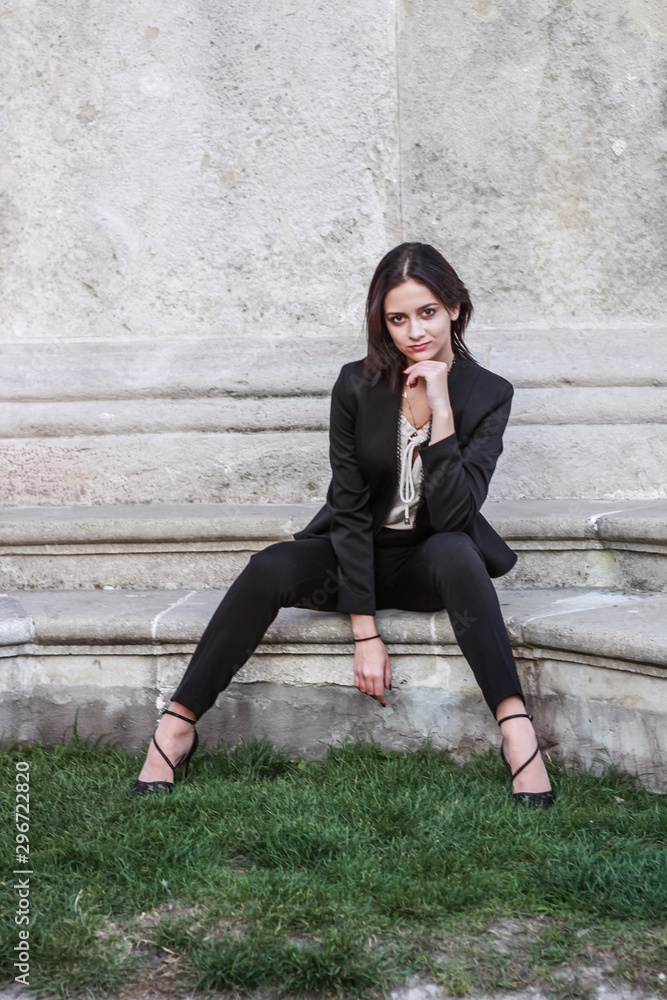 Black haired girl.Business woman in black classic suit.White blouse.Fashion style. Black haired girl.Business woman in black classic suit.White blouse.Fashion style.