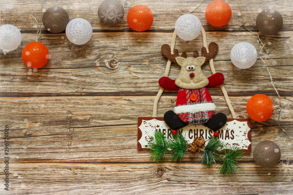 Wooden background with decoration balls and Christmas deer on the table. Winter holiday frame. Flat lay top view. copy space Wooden background with decoration balls and Christmas deer on the table. Winter holiday frame. Flat lay top view. copy space