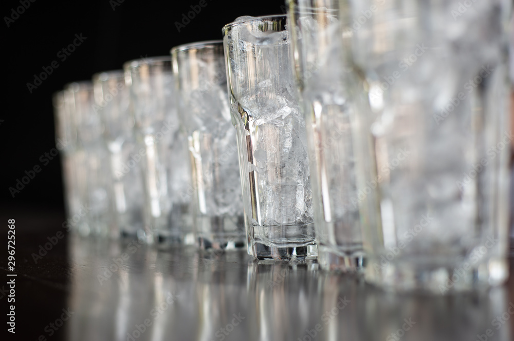 Glass of water that is filled with ice and arranged in rows. Glass of water that is filled with ice and arranged in rows.