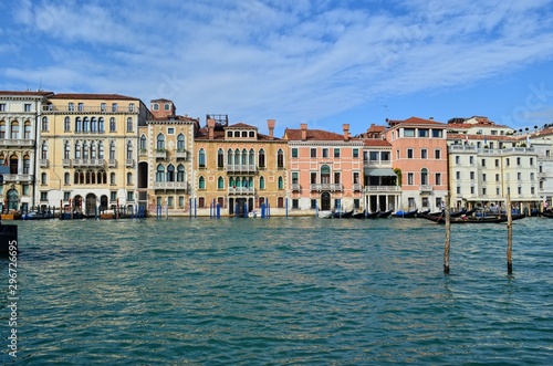 wide Venetian canal with houses having a characteristic local style © Anastassiya