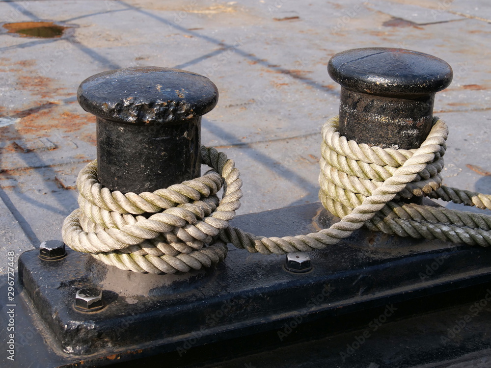Fototapeta premium Black bollards on the harbor wall for attachment to the ship