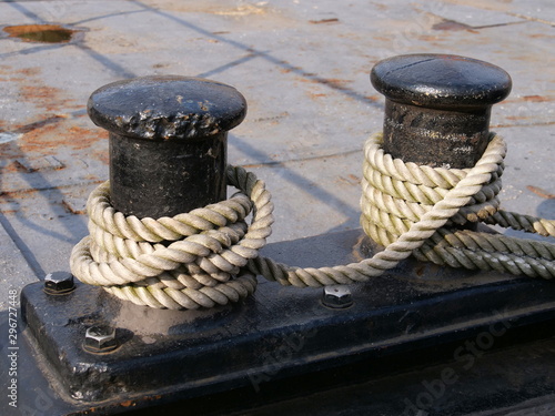Black bollards on the harbor wall for attachment to the ship