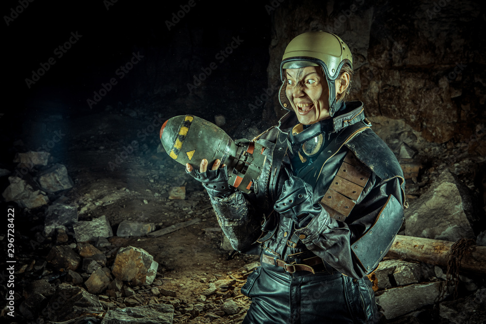 Fototapeta premium Soldier woman with the bomb on post apocalyptic background.