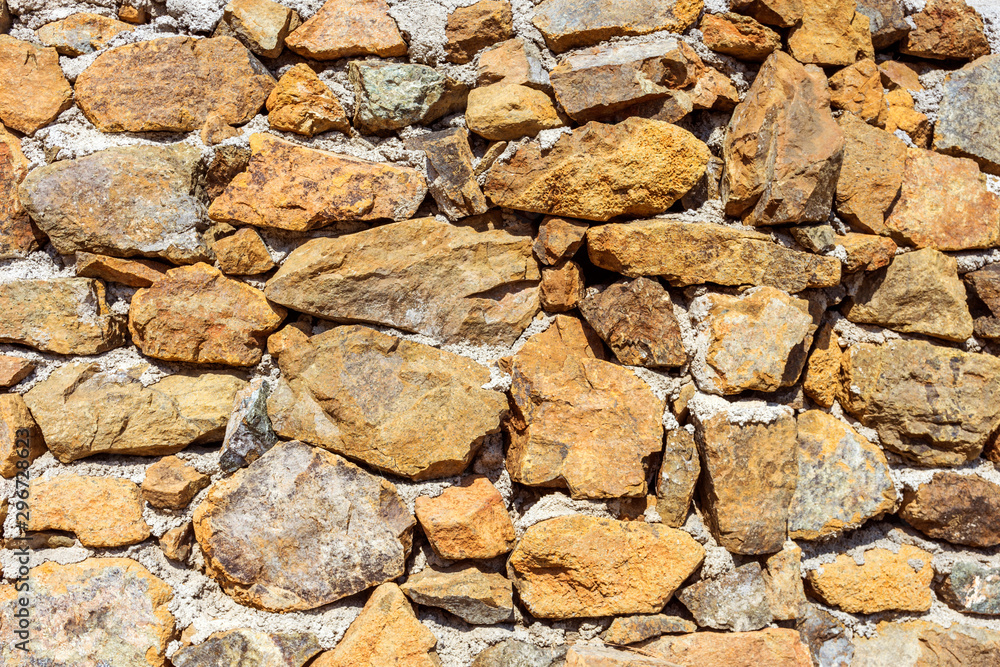 Stone wall with cement. Decorative uneven cracked stone is a real stone wall. Stone wall with cement. Decorative uneven cracked stone is a real stone wall.