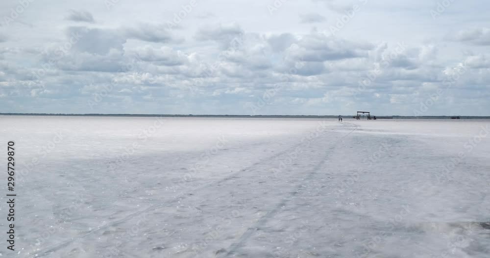 Flooding on salt lake flooded entire coast and beach, railway under water, white spots of salt deposits are visible, beautiful landscape, panorama of crane, horizon line, stunning sky above water Flooding on salt lake flooded entire coast and beach, railway under water, white spots of salt deposits are visible, beautiful landscape, panorama of crane, horizon line, stunning sky above water