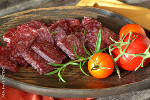 Flat dry salami or sausages. Gourmet meat. Delicacy salami.