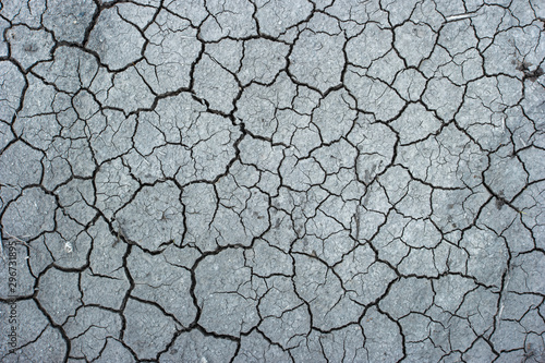 Photo of cracked dry land soil from above