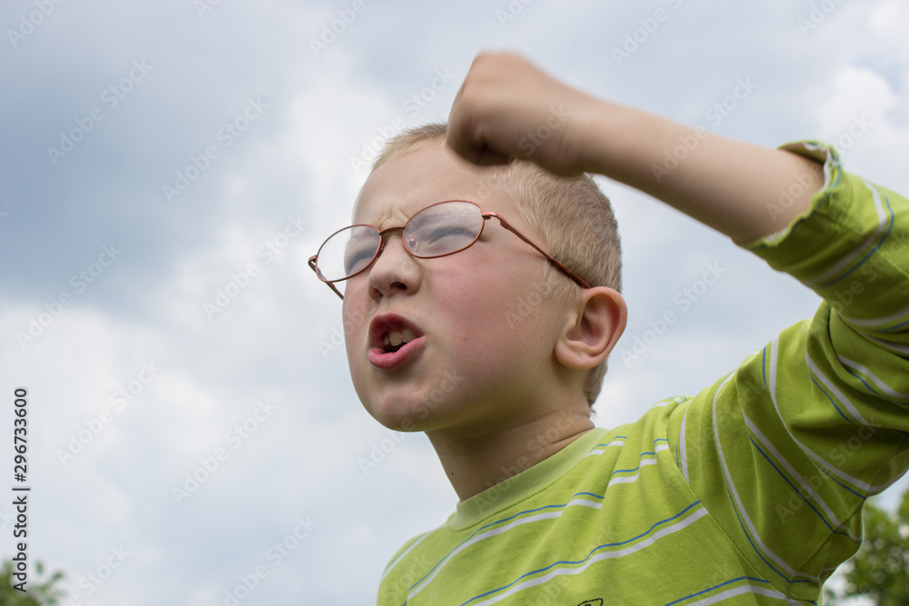 boy hands showing emotions,boy in glasses protests waving his hands boy hands showing emotions,boy in glasses protests waving his hands