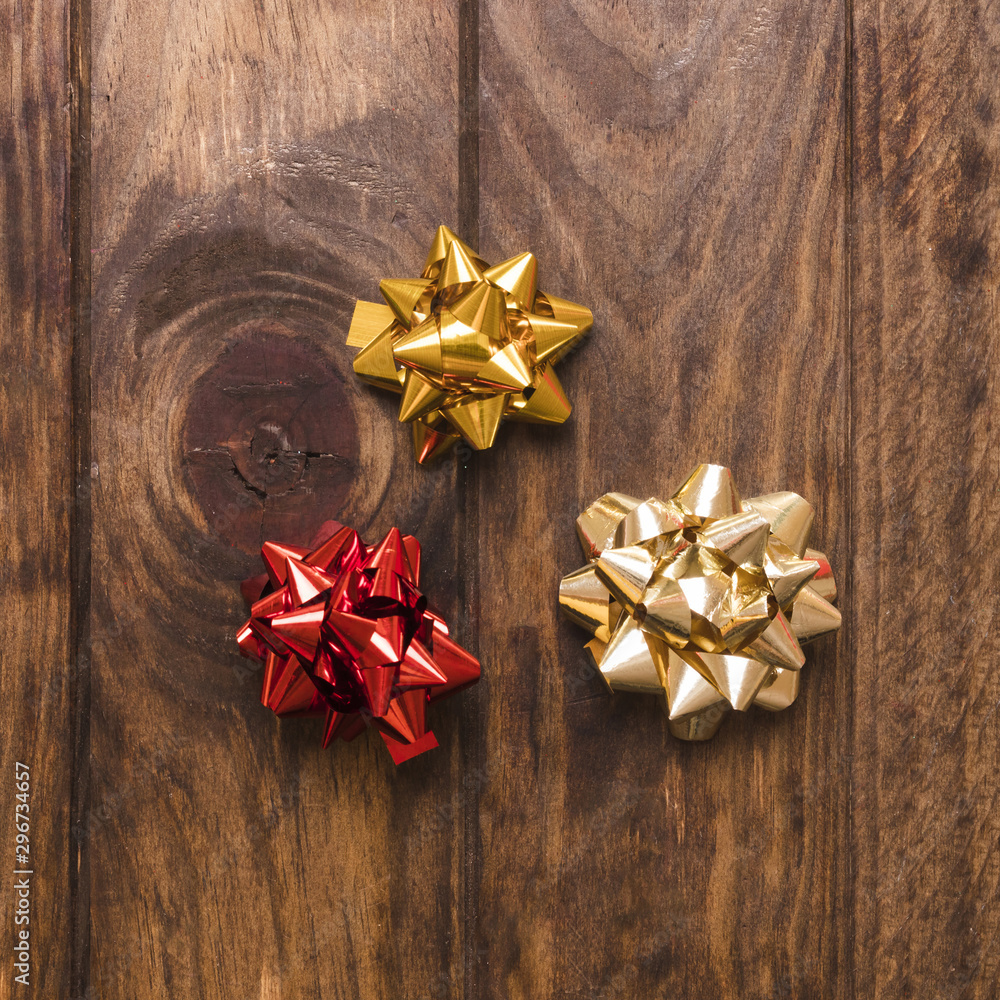 Shiny bows on lumber tabletop Shiny bows on lumber tabletop