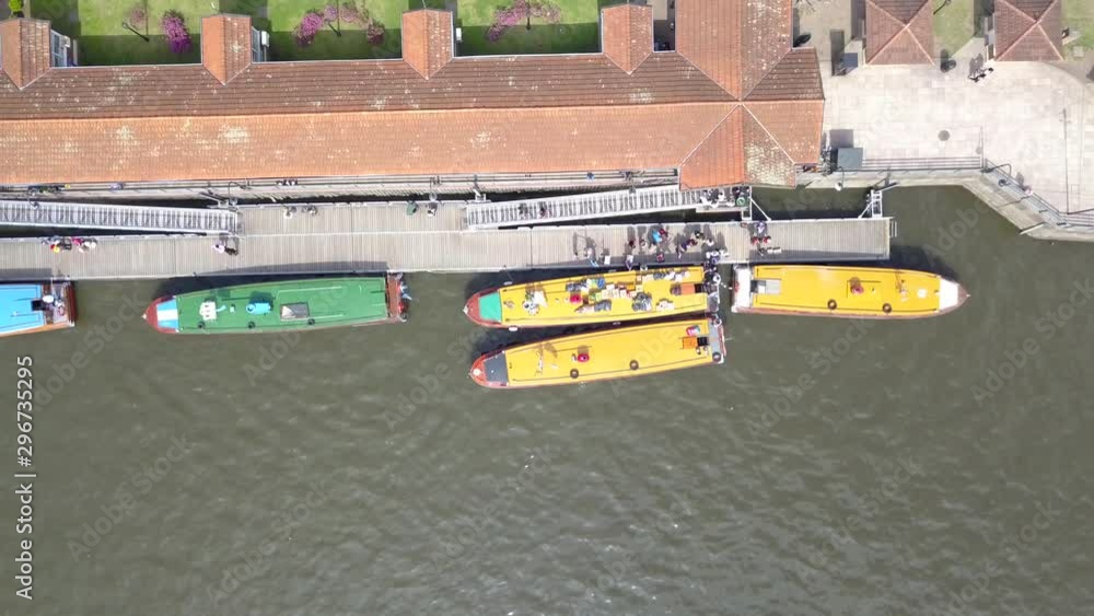 Aerial top down shot of people walking and boarding on boats in Tigre, Buenos Aires Aerial top down shot of people walking and boarding on boats in Tigre, Buenos Aires