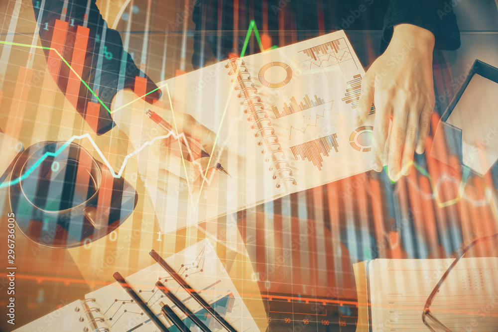 Double exposure of hands making notes with forex chart huds. Stock market concept. Double exposure of hands making notes with forex chart huds. Stock market concept.