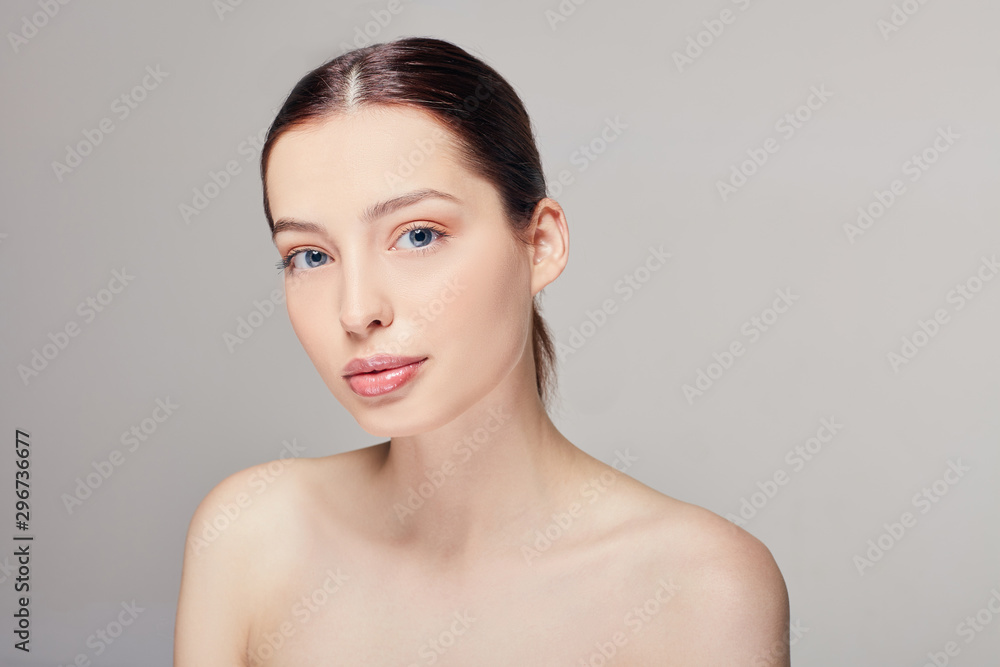 Beautiful young woman with clean fresh skin looking straight. Cosmetology, beauty and spa. Face care. Beautiful young woman with clean fresh skin looking straight. Cosmetology, beauty and spa. Face care.