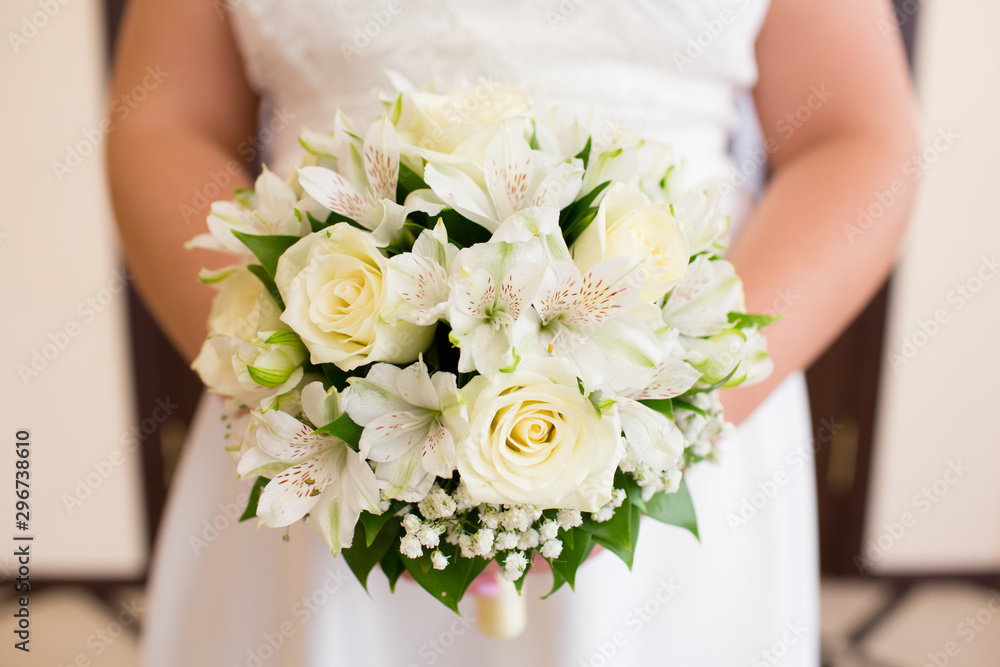 Beautiful wedding bouquet of flowers in the hands of the bride Beautiful wedding bouquet of flowers in the hands of the bride