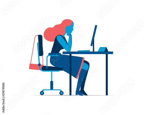 An employee works at the office desk