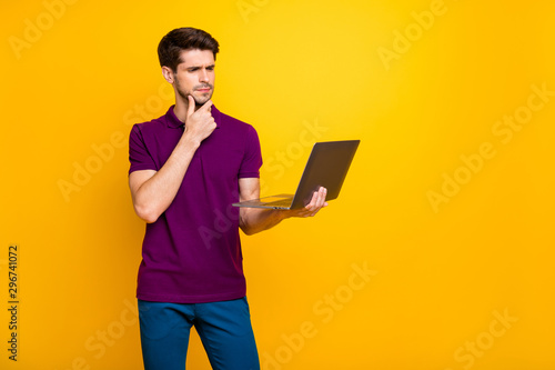 Portrait of his he nice attractive minded serious focused guy finance market marketer analyst using laptop isolated over bright vivid shine vibrant yellow color background