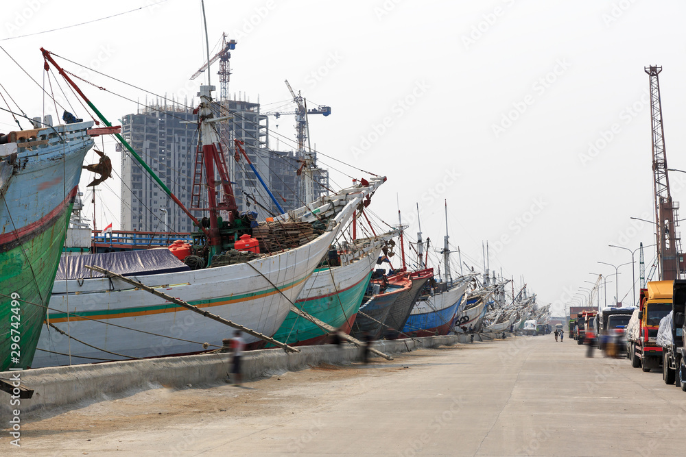 Beautiful view of traditional Pinisi vessels of the Lamba (or Lambo) type in the old Sunda Kelapa harbor of Jakarta, Indonesia Beautiful view of traditional Pinisi vessels of the Lamba (or Lambo) type in the old Sunda Kelapa harbor of Jakarta, Indonesia