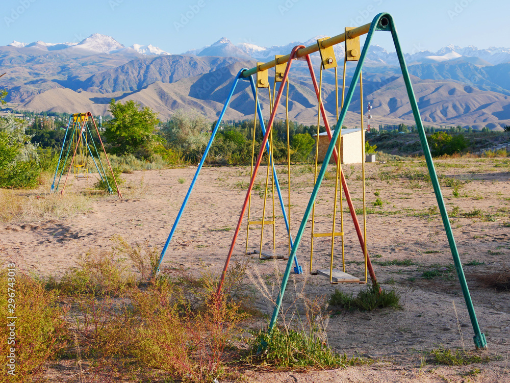 Swing on abandoned playground in Kyrgyzstan Swing on abandoned playground in Kyrgyzstan