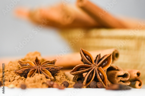 Cinnamon sticks and Star Anise on cinnamon powder herbs and spices on white