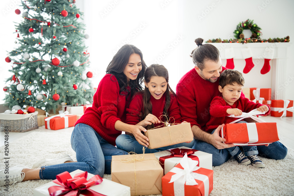 Portrait of four nice attractive lovely idyllic sweet adorable cheerful dreamy big full foster family celebrating spending newyear leisure eve noel festal day light white interior living-room