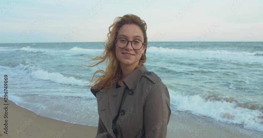portrait of young redhead woman in glasses on the seaside during sunset portrait of young redhead woman in glasses on the seaside during sunset