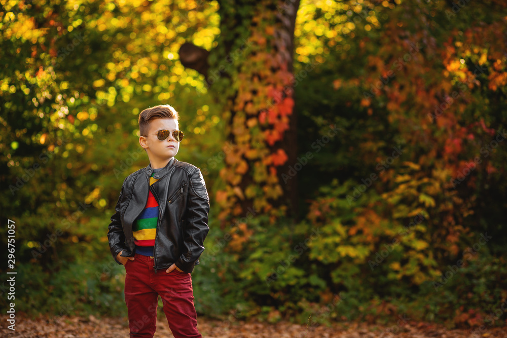 child in sunglasses.fashionable handsome little boy in black leather bikers' jacket. child in sunglasses.fashionable handsome little boy in black leather bikers' jacket.