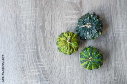 Green pumpkins on wooden background