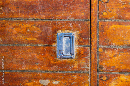 Wooden deck old shabby with a handle from the hatch