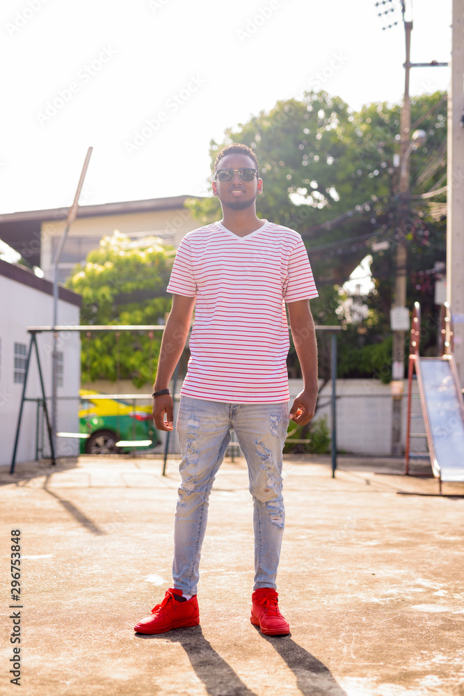 custom made wallpaper toronto digitalFull body shot of happy young African man with sunglasses smiling at playground