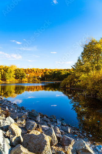 Fototapeta Naklejka Na Ścianę i Meble -  autumn landscape with blue sky and a small lake