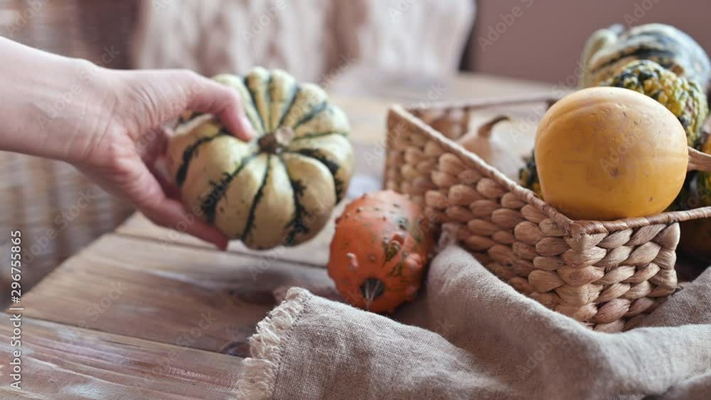 pumpkins on an autumn table in a wicker basket. The atmosphere of comfort and coziness. pumpkins on an autumn table in a wicker basket. The atmosphere of comfort and coziness.
